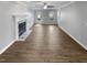 Bright living room with fireplace, wood floors, and ample natural light at 4216 High Mountain Dr, Raleigh, NC 27603