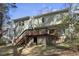 Back exterior showing the second story deck with stairs and the beautifully landscaped backyard at 4815 Fortunes Ridge Dr, Durham, NC 27713