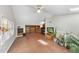 Open bonus room with unique flooring, ceiling fan, and built-in shelving at 4815 Fortunes Ridge Dr, Durham, NC 27713