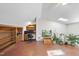 Bright bonus room with sloped ceiling, built-in shelving, ceiling fan, and terra cotta flooring at 4815 Fortunes Ridge Dr, Durham, NC 27713