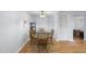 Cozy dining area with hardwood floors and traditional-style table and chairs with classic light fixture at 4815 Fortunes Ridge Dr, Durham, NC 27713