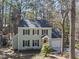 Charming two-story home with a red front door and black shutters nestled among mature trees at 4815 Fortunes Ridge Dr, Durham, NC 27713
