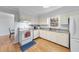 Functional kitchen featuring white cabinets, granite countertops, and modern appliances at 4815 Fortunes Ridge Dr, Durham, NC 27713