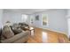 Cozy living room with hardwood floors and natural light from large windows at 4815 Fortunes Ridge Dr, Durham, NC 27713