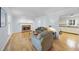 Bright living room featuring a cozy fireplace, neutral paint, and hardwood floors at 4815 Fortunes Ridge Dr, Durham, NC 27713