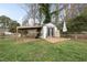 Backyard shed features storage and a covered area, perfect for hobbies or outdoor equipment, blending functionality with design at 4900 Skidmore St, Raleigh, NC 27609