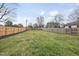 Spacious backyard featuring a secure wooden fence, offering privacy and ample space for outdoor activities and gardening at 4900 Skidmore St, Raleigh, NC 27609