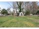 A backyard features a versatile shed, perfect for storage or hobbies, enhancing the outdoor living space at 4900 Skidmore St, Raleigh, NC 27609