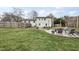 The expansive backyard features a stone patio, seating area, and lush lawn, ideal for outdoor living and entertaining at 4900 Skidmore St, Raleigh, NC 27609
