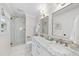 Elegant bathroom with a double sink vanity, marble countertop, glass-enclosed shower, and tasteful fixtures at 4900 Skidmore St, Raleigh, NC 27609