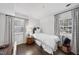 This bright bedroom boasts hardwood floors, two windows, and is decorated with a blue and white color scheme at 4900 Skidmore St, Raleigh, NC 27609