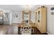 Inviting dining room with a wooden table, elegant white chairs, and a charming display cabinet at 4900 Skidmore St, Raleigh, NC 27609