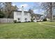 Charming two-story home featuring a brick chimney, a welcoming porch, and well-manicured landscaping at 4900 Skidmore St, Raleigh, NC 27609