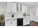 Well-lit kitchen featuring white cabinets, quartz countertops, and a built-in beverage refrigerator at 4900 Skidmore St, Raleigh, NC 27609