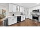 Modern kitchen with white cabinets, stainless steel appliances, and a convenient beverage refrigerator at 4900 Skidmore St, Raleigh, NC 27609