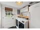 Functional laundry room featuring modern washer and dryer, butcher block countertops, and convenient storage space at 4900 Skidmore St, Raleigh, NC 27609
