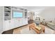 Bright living room featuring built-in shelving, hardwood floors, neutral furniture, and stylish decor at 4900 Skidmore St, Raleigh, NC 27609
