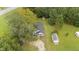 Birds eye view of the home and sheds surrounded by lush green trees and lawn at 501 E Granville St, Dunn, NC 28334
