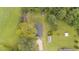 Overhead view of the home with sheds surrounded by trees and green grass at 501 E Granville St, Dunn, NC 28334