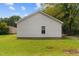 A large backyard with a shed on a sunny day at 501 E Granville St, Dunn, NC 28334