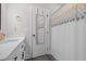 Bathroom featuring white vanity, patterned shower curtain, and wood-look floors at 501 E Granville St, Dunn, NC 28334