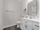 Bathroom featuring white vanity, toilet, and a mirror above the sink, with vinyl plank flooring at 501 E Granville St, Dunn, NC 28334