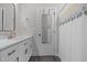 Bathroom featuring white vanity, patterned shower curtain, and wood-look floors at 501 E Granville St, Dunn, NC 28334