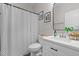 Well-lit bathroom featuring a modern vanity, decorative mirror, and stylish shower curtain at 501 E Granville St, Dunn, NC 28334