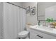 Stylish bathroom featuring modern vanity, framed mirror, and a shower/tub combo with patterned curtain at 501 E Granville St, Dunn, NC 28334