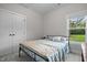 Comfortable bedroom with large window, neutral walls, double door closet and plush carpet at 501 E Granville St, Dunn, NC 28334