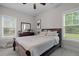 Bright bedroom featuring two windows, wood furniture, and luxury vinyl tile floors at 501 E Granville St, Dunn, NC 28334