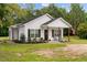 Charming front view of a bright white home featuring a cozy front porch at 501 E Granville St, Dunn, NC 28334
