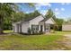 Exterior side view of a white home with a front porch and manicured lawn at 501 E Granville St, Dunn, NC 28334