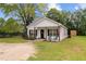 Inviting front view of a cozy white home with a landscaped yard and welcoming porch at 501 E Granville St, Dunn, NC 28334