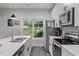 A bright kitchen with stainless steel appliances, white cabinets, an island sink, and a view to the yard at 501 E Granville St, Dunn, NC 28334