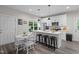 Bright kitchen with a breakfast bar, stainless appliances, and abundant white cabinetry at 501 E Granville St, Dunn, NC 28334