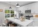 A bright kitchen with a quartz countertop island, stainless steel appliances and white cabinets at 501 E Granville St, Dunn, NC 28334