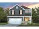 Charming two-story home with gray siding, white trim, and a welcoming two-car garage at 509 Providence Springs Ln, Fuquay Varina, NC 27526