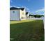 Large, fenced backyard featuring lush green grass and ample space for outdoor activities at 5117 Farm Barn Ln, Raleigh, NC 27603