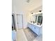Bright bathroom features a double vanity with blue cabinets, granite countertops, and modern fixtures at 5117 Farm Barn Ln, Raleigh, NC 27603