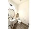 This powder room features a pedestal sink, decorative mirror and floating wood shelves at 5117 Farm Barn Ln, Raleigh, NC 27603
