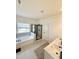 Spacious bathroom featuring a soaking tub, walk-in shower with glass door, and vanity with granite countertop at 5117 Farm Barn Ln, Raleigh, NC 27603