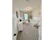 Light-filled bedroom features a white crib, cushioned chair, and patterned wallpaper at 5117 Farm Barn Ln, Raleigh, NC 27603
