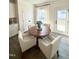 Bright dining area features a round wood table and four white cushioned chairs perfect for Gathering meals at 5117 Farm Barn Ln, Raleigh, NC 27603