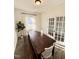 Cozy dining room with a wooden table, white chairs, and ample natural light at 5117 Farm Barn Ln, Raleigh, NC 27603