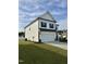 White two-story home with black trim, a garage, and a well-maintained lawn at 5117 Farm Barn Ln, Raleigh, NC 27603