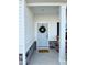Covered entrance to this lovely home has natural stone accents, rocking chairs, and a wreath-adorned door at 5117 Farm Barn Ln, Raleigh, NC 27603