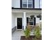 Inviting front porch featuring rocking chairs and decorative hanging flower baskets at 5117 Farm Barn Ln, Raleigh, NC 27603