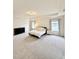 Spacious main bedroom features neutral carpet, tray ceiling, two windows with gray curtains, and dark dresser at 5117 Farm Barn Ln, Raleigh, NC 27603