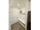 Mud room with built-in bench, coat hooks, shelf, and gray vinyl floors at 5117 Farm Barn Ln, Raleigh, NC 27603